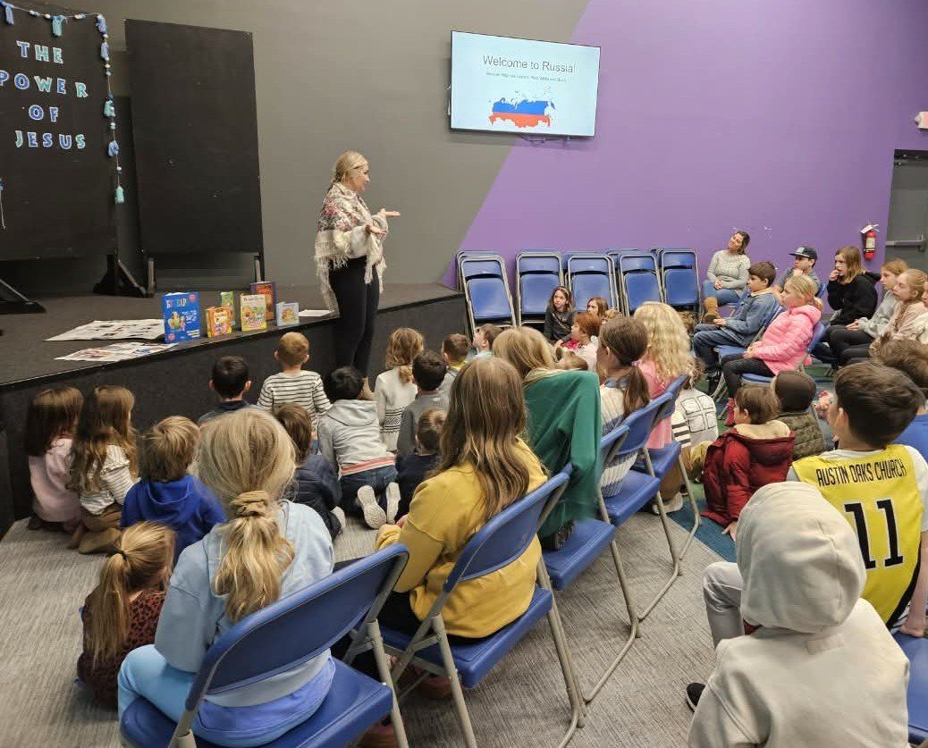 A guest presenter giving a Welcome to Russia talk to students seated in rows