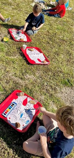 Two children drawing and watercoloring side by side